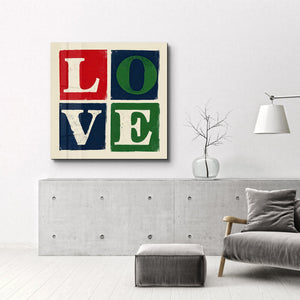 Retro kare glass wall art featuring "Love Blocks" typography by Artdesigna, with colorful geometric design on clear glass.