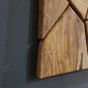 Handmade olive wood geometric wall sculpture by Artdesigna, featuring intricate wooden patterns perfect for modern wall decor.